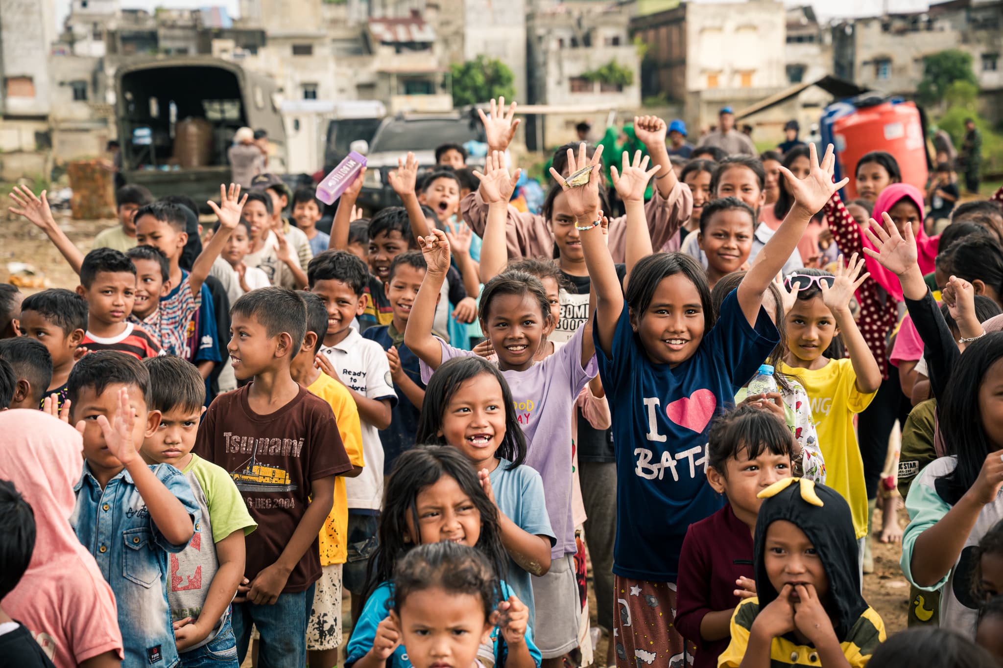 Children cheering with raised hands in Aceh